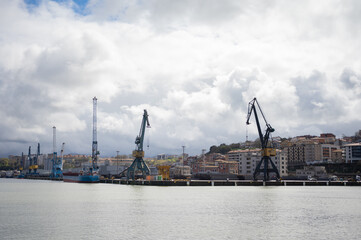 Industrial view. Working crane in the port, The Cargo in the Port Pier at the Loading of Coal. Loader and conveyors to transport coal.