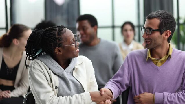 close up. smiling guy shaking hands with his friend