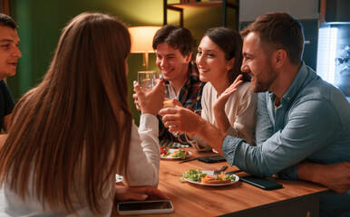 Group of people are on the kitchen, having dinner, spending time together