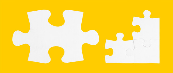 Three connected and one disconnected jigsaw puzzle pieces isolated on yellow background.