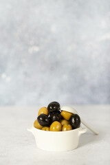green and black olives on a light background
