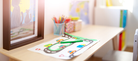 Closeup view of the child's drawing on the table in the children room.