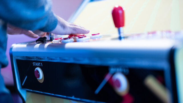 Close-up of a Person Enjoying an Arcade Game - Powered by Adobe