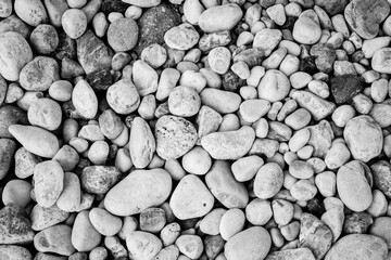 Pebble background, top view. Beach pebbles for publication, design, poster, calendar, post, screensaver, wallpaper, card, banner, cover, website. Gray toned high quality photo
