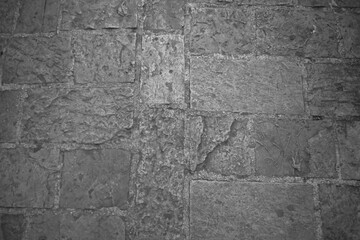 Cobblestone tiles street with big stones, top view. Ancient stone floor. Old pavement for a poster, calendar, post, screensaver, wallpaper, postcard, cover, web. Gray toned high quality photo