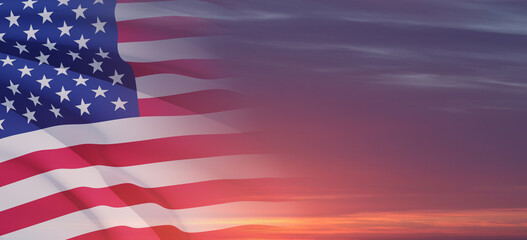 United States of America flag on sky at sunset or sunrise background.