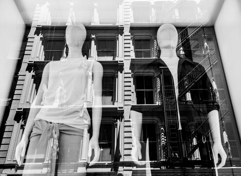 Fashion mannequins in a shop window with a reflection of a house - Manhattan, New York - Black and White