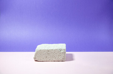 white brick podium on soft pink and blue background, beauty concept, isolated, copy space 