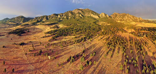 Morning sunlight bathes the landscape and mountains of Bear Peak and Green Mountain just after sunrise in the city of Boulder, Colorado in winter. © pics721