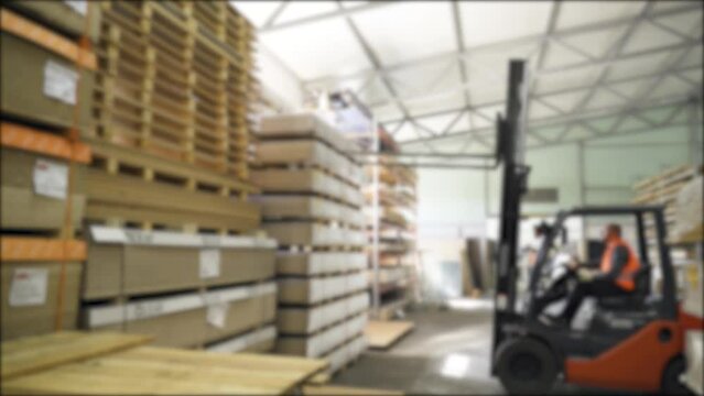 Background blur video of a forklift working in a warehouse.