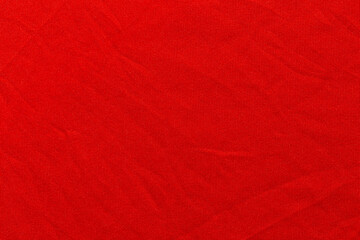 Red color sports clothing fabric football shirt jersey texture and textile background.