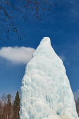 ice waterfall. a spring frozen in winter that springs from the ground