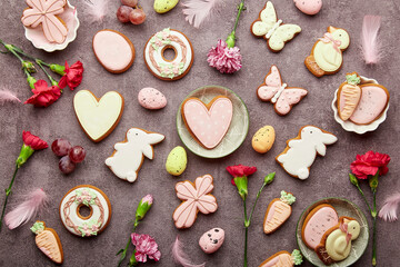 Aesthetic Happy Easter background. Easter glazed cookies, aster flowers, grapes. Seasonal spring background.