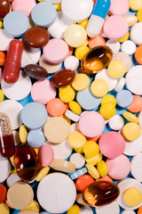Background with the many colorful different capsules and pills. The concept of medical treatment