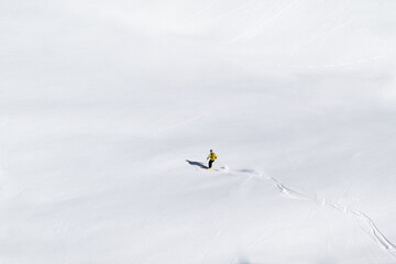 Single offpiste skier making fresh tracks in powder snow
