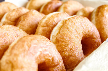 Donuts on a tray close-up, selective focus. Delicious homemade donuts. A traditional Hanukkah treat. The concept of celebrating Hanukkah.