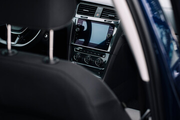 Obraz premium Modern car interior, control details, aluminum, leather steering wheel, Alcantara, car multimedia shown in the car interior.