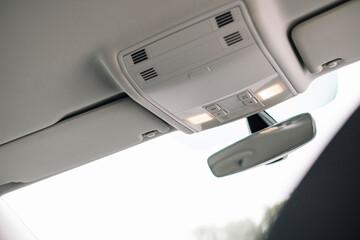 Modern car interior, rear-view mirror with dimming function, LED interior lighting.