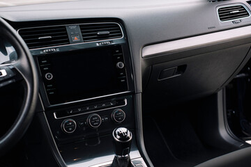 Fototapeta na wymiar Modern car interior, control details, aluminum, leather steering wheel, Alcantara, car multimedia shown in the car interior.