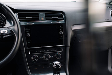 Plakat Modern car interior, control details, aluminum, leather steering wheel, Alcantara, car multimedia shown in the car interior.