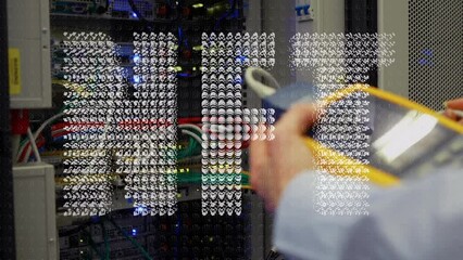 Animation of nft text over caucasian businessman in server room - Powered by Adobe