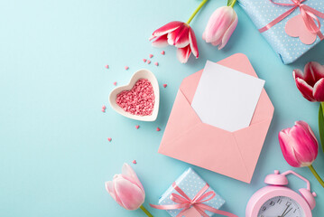 Mother's Day concept. Top view photo of pink open envelope with letter tulips gift boxes alarm clock and heart shaped saucer with sprinkles on isolated pastel blue background with blank space
