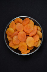 Juicy dried apricots in a glass bowl. Dried apricot fruit halves without a stone.