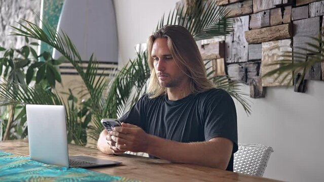 American freelancer home distant work. Busy person typing computer macbook cowork cafe. Boss man look screen monitor. Male guy sit study office. Long hair people use laptop. Online remote internet job
