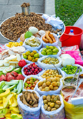 A mix of sliced tropical fruit and raw peanuts,,on sale along the Riverside of Phnom Penh,Cambodia.