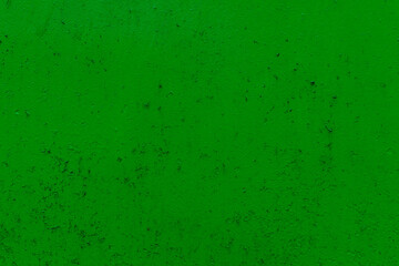 Fototapeta na wymiar Green poorly painted metal fence as a background, pattern, texture