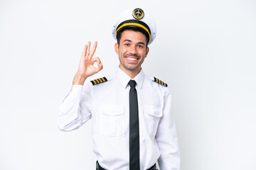 Airplane pilot over isolated white background showing ok sign with fingers