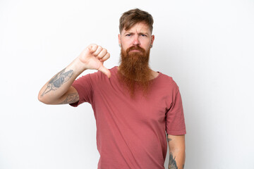 Redhead man with long beard isolated on white background showing thumb down with negative expression