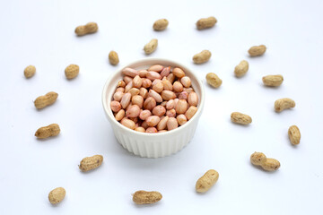 Raw peanuts on white background.