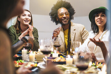 Multiracial Friends Enjoying a Warm Dinner Party at Home