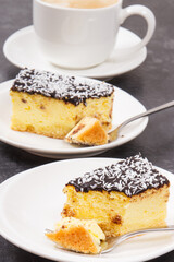 Fresh baked cheesecake and cup of white coffee. Delicious dessert