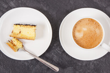 Fresh baked cheesecake and cup of white coffee. Delicious dessert