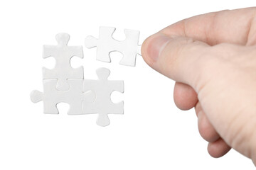 Hand inserting missing piece of puzzle, cut out