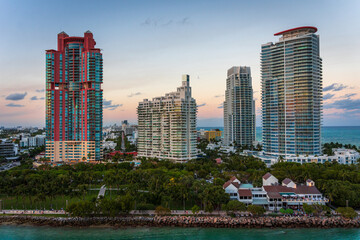 Fototapeta na wymiar Miami Beach buildings on the water at the Port of Miami at sunset 