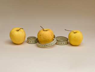Ripe yellow apples with centimeter and space for text