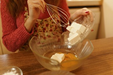 Close-up shot of mixing ingredients for making cakes, cookies or pastries. Detail images of beating butter, flour and eggs for dough making.