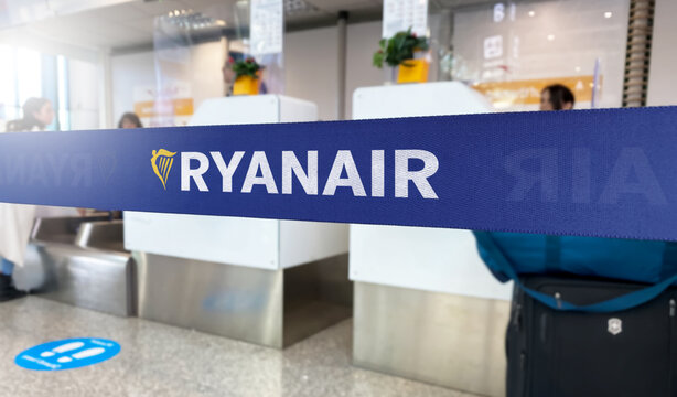 Blue barrier tape with the Ryanair logo inside an airport