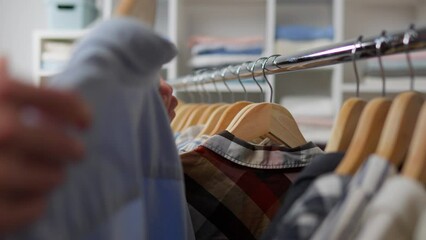 The employee restocks the shelves, ensuring that all items are organized and displayed attractively. the clothing store owner oversees the operation, making sure that everything is running smoothly