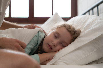 A father enjoys talking with his daughter in his bedroom. before saying goodbye and sending her daughter to bed