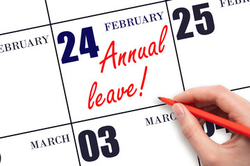 Hand writing the text ANNUAL LEAVE and drawing the sun on the calendar date February 24