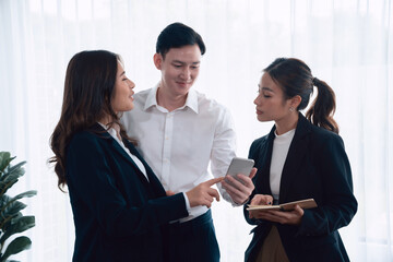 Mentor, manager advice younger colleagues in workplace. Businesspeople discussing or planning...