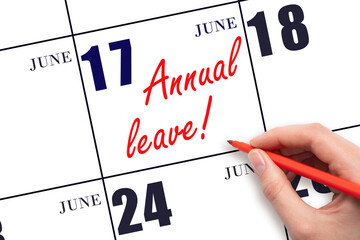 Hand writing the text ANNUAL LEAVE and drawing the sun on the calendar date June 17