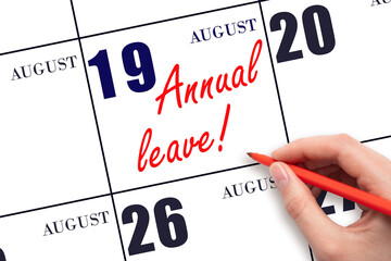 Hand writing the text ANNUAL LEAVE and drawing the sun on the calendar date August 19