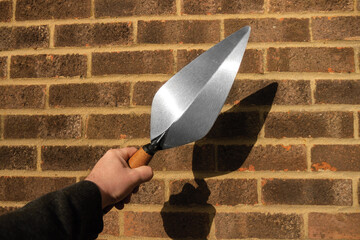 holding a brick trowel