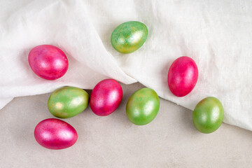 Colored red and green Easter eggs with fabric, top view.