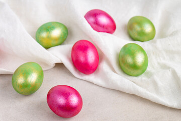 Colored red and green Easter eggs with fabric, top view.